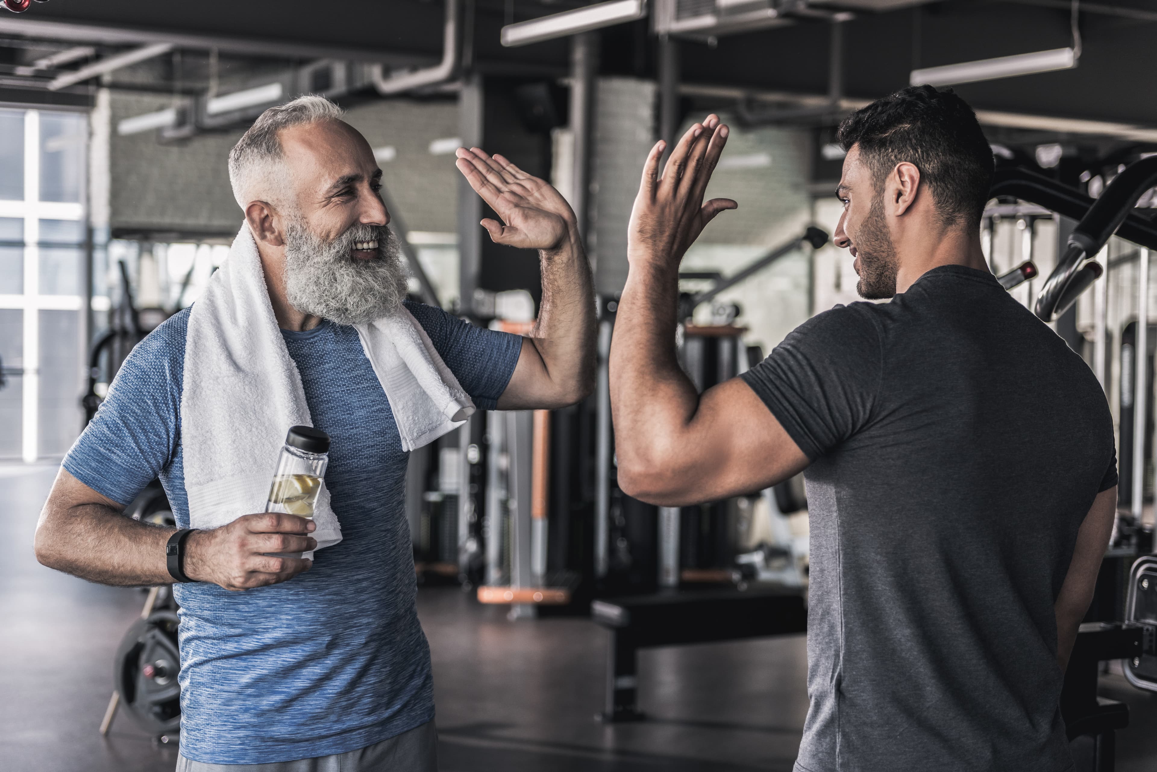 Man lifting barbell in gym