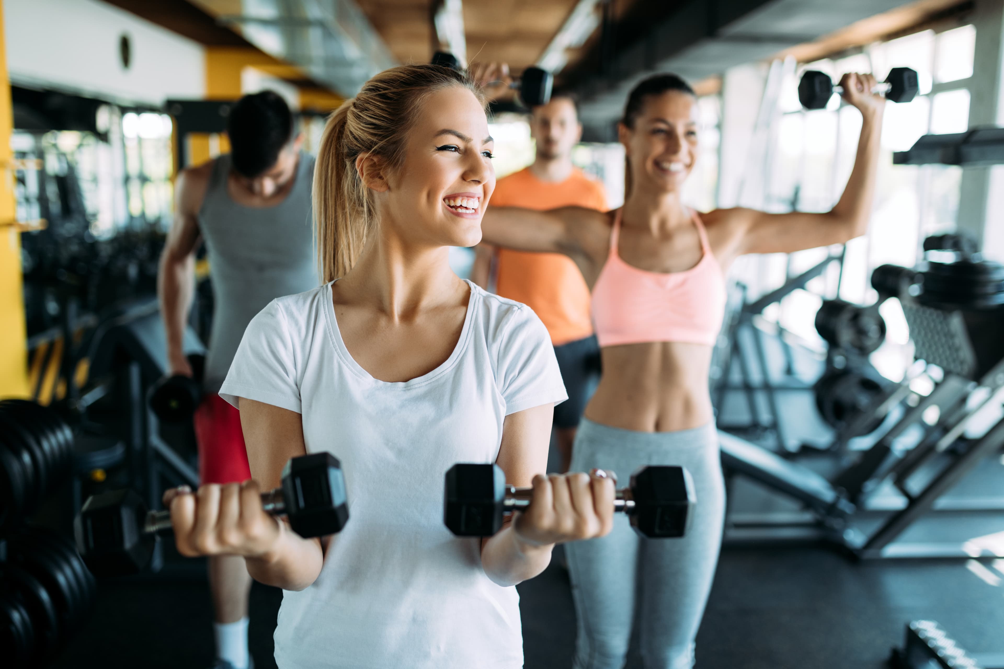 Two men high-fiving in gym